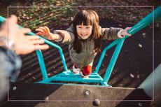 Kid with brunette hari climbing green slide