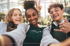 Portrait of three teenagers taking a selfie with a mobile phone