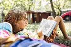 Child reading in the sunshine 