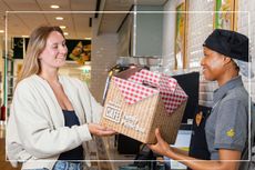 Morrisons' Family Picnic Box being handed to a woman in a Morrisons Cafe