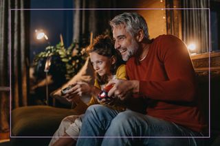 Man and teen girl play on games console