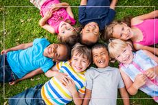 Tweens laying on the floor in a circle