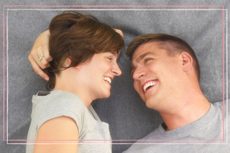 man and woman lying down and laughing together