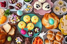 A table full of delicious easter desserts cakes and puddings