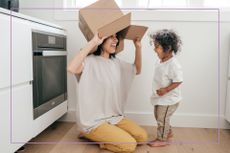 things to do with toddlers illustrated by Toddler playing with card board